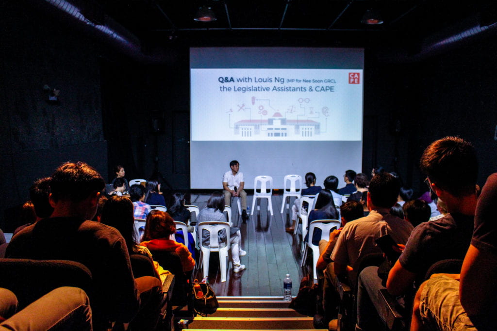photo of MP Louis Ng during a Q&A with a packed auditorium